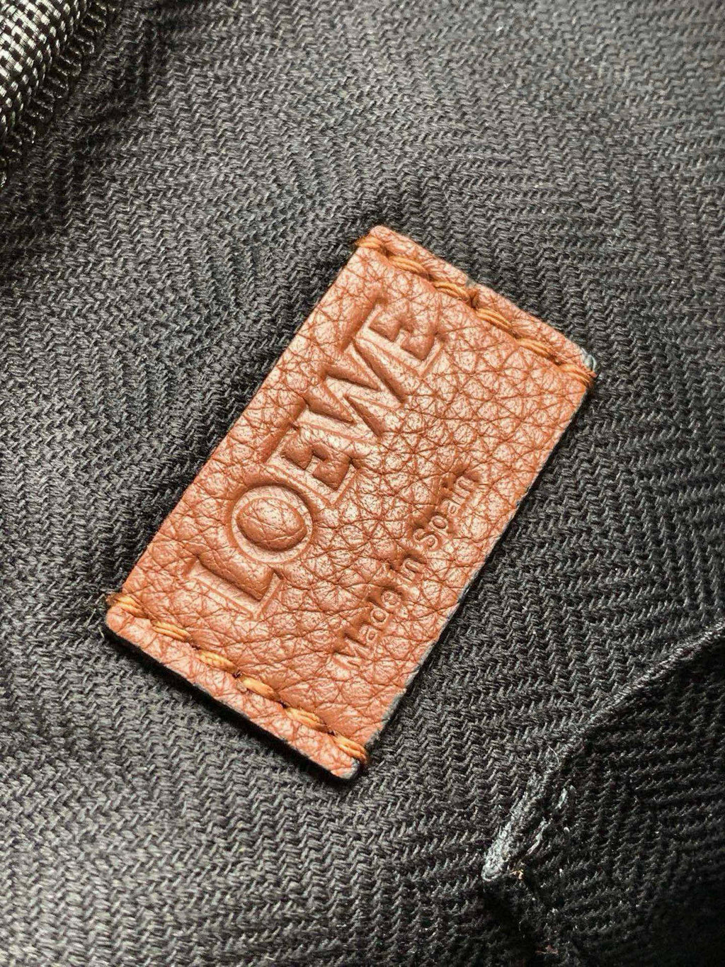 Loewe men's leather logo patch label stitched on bag lining