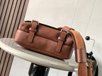 Leather crossbody bag with top strap and embossed logo on front flap