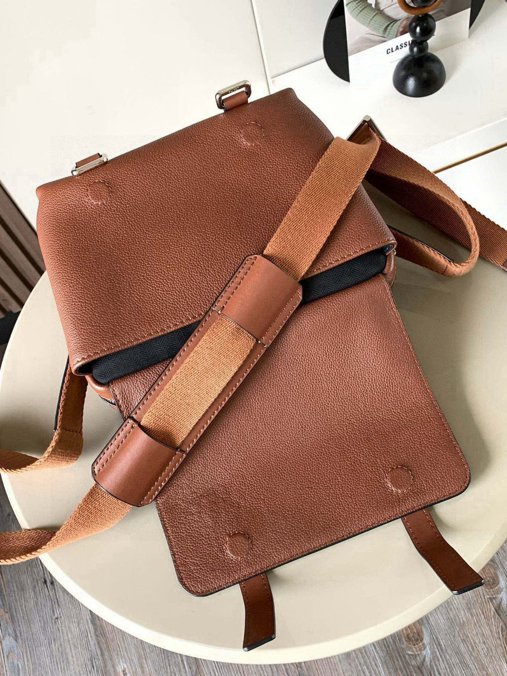 Loewe men's small leather shoulder bag with flap closure and logo detailing