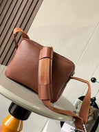 Loewe men's small leather crossbody bag with front flap and long shoulder strap
