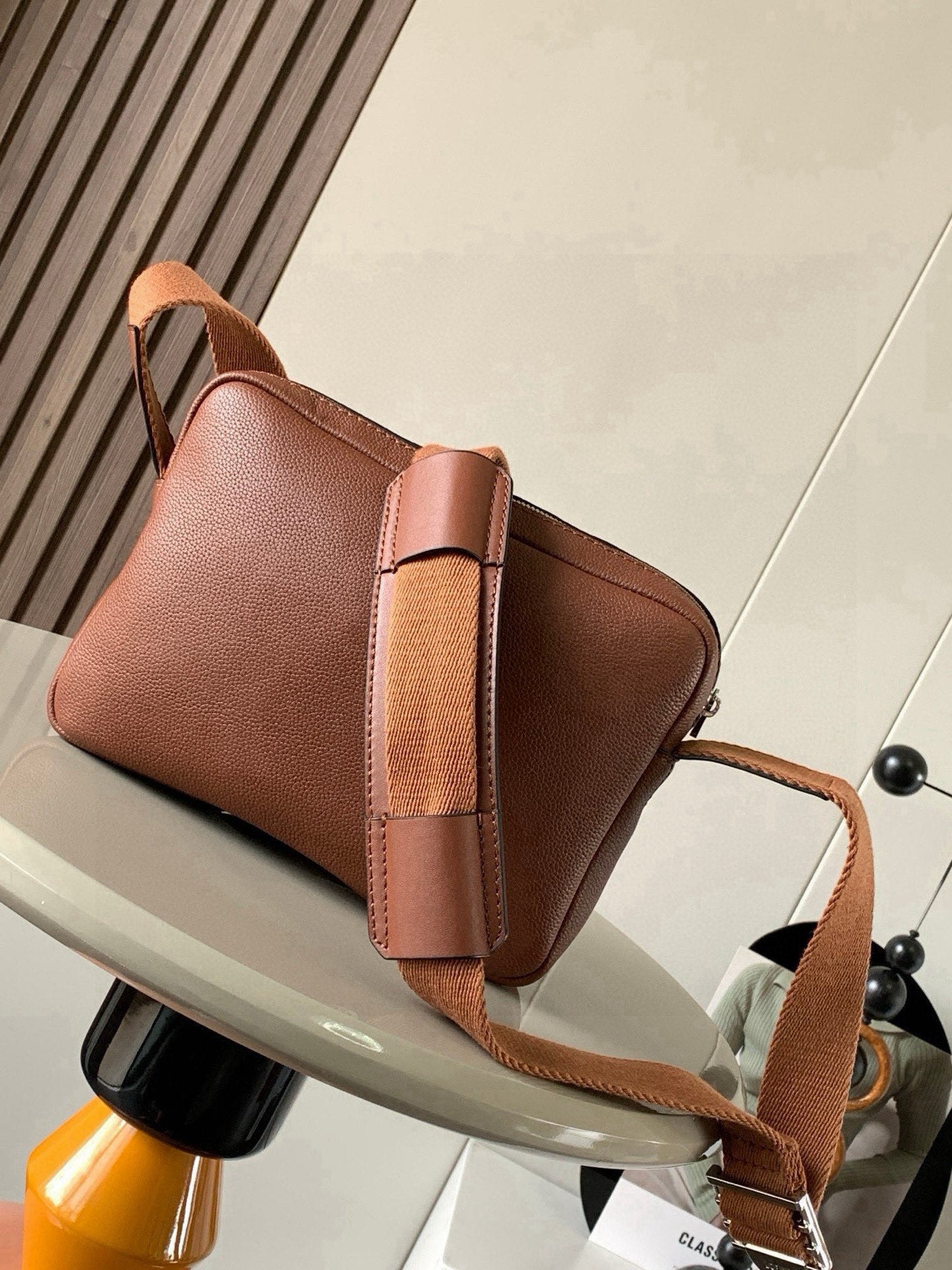 Loewe men's small leather crossbody bag with front flap and long shoulder strap