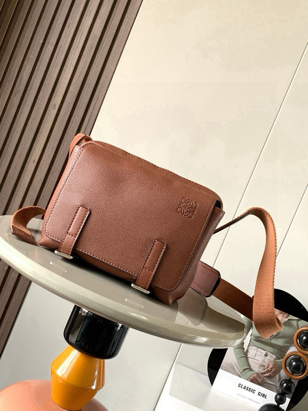 Loewe men's small leather crossbody bag with front flap and buckle straps