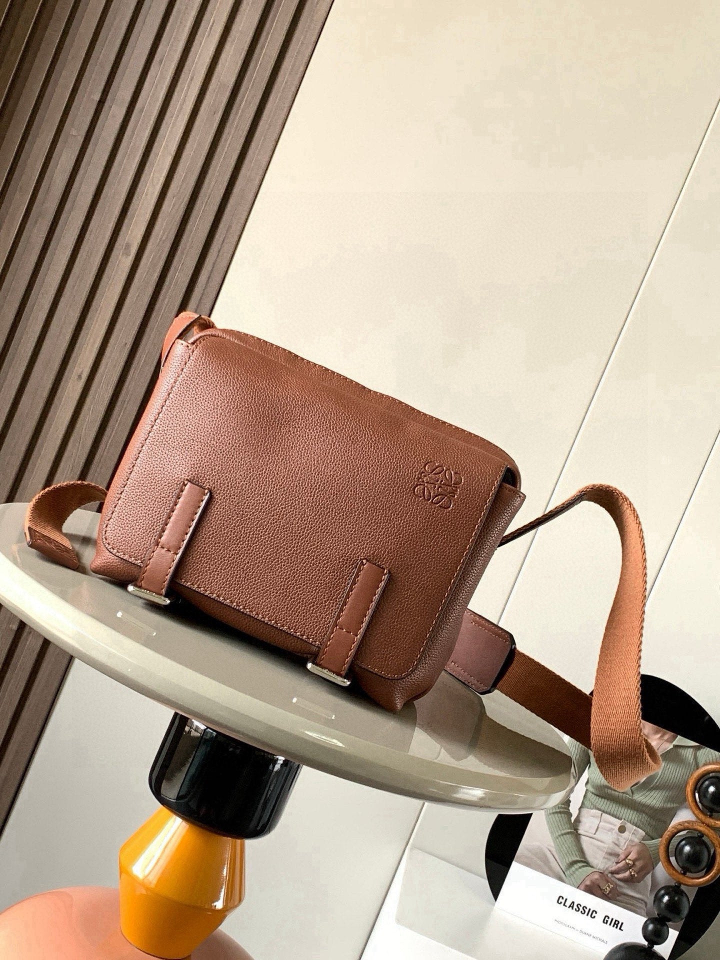 Loewe men's small leather crossbody bag with front flap and buckle straps