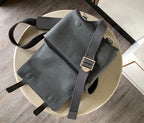 Loewe men’s leather crossbody bag in dark gray on light surface, full bag view
