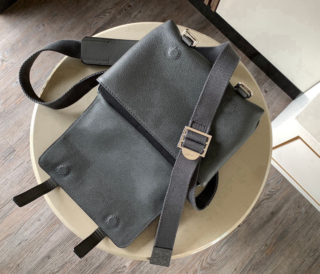 Loewe men’s leather crossbody bag in dark gray on light surface, full bag view
