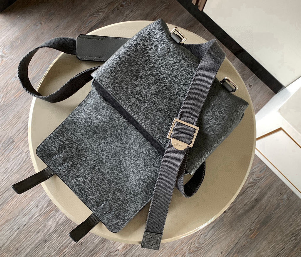 Gray leather mini crossbody bag with front flap pocket and buckle strap