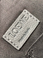 Loewe men’s leather bag label patch in gray with printed text on fabric