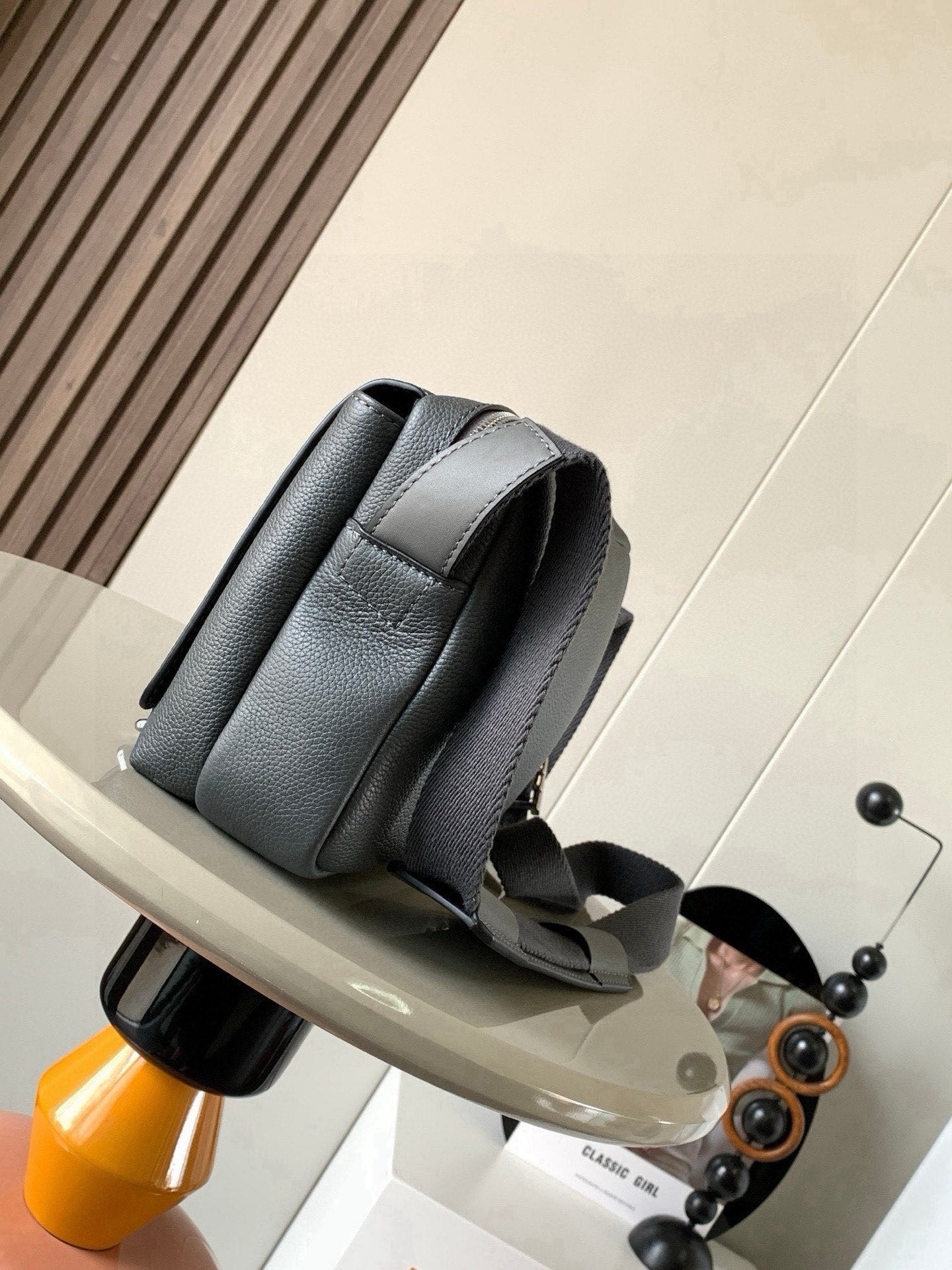 Loewe men’s leather crossbody bag, dark gray, side view with strap loops