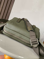 Sage green crossbody bag with top zipper and adjustable strap with metal clasp