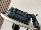 Loewe crossbody bag in dark leather with structured flap and metal buckles on straps.