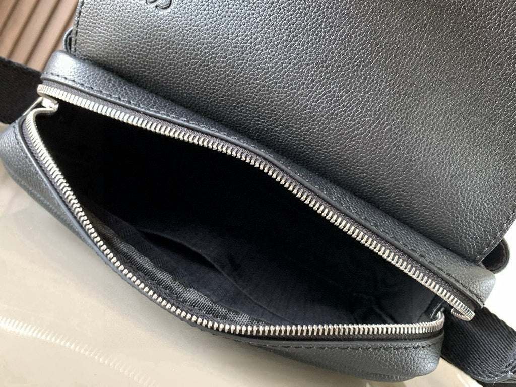 Dark leather bag with silver zipper opening showing black interior lining