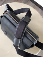Dark leather sling bag with zip closure and adjustable crossbody strap