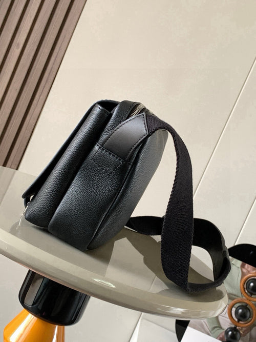 Dark leather crossbody bag with curved front panel and wide shoulder strap