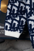 Knit cardigan sleeve with ribbed white cuff and navy-and-white geometric pattern