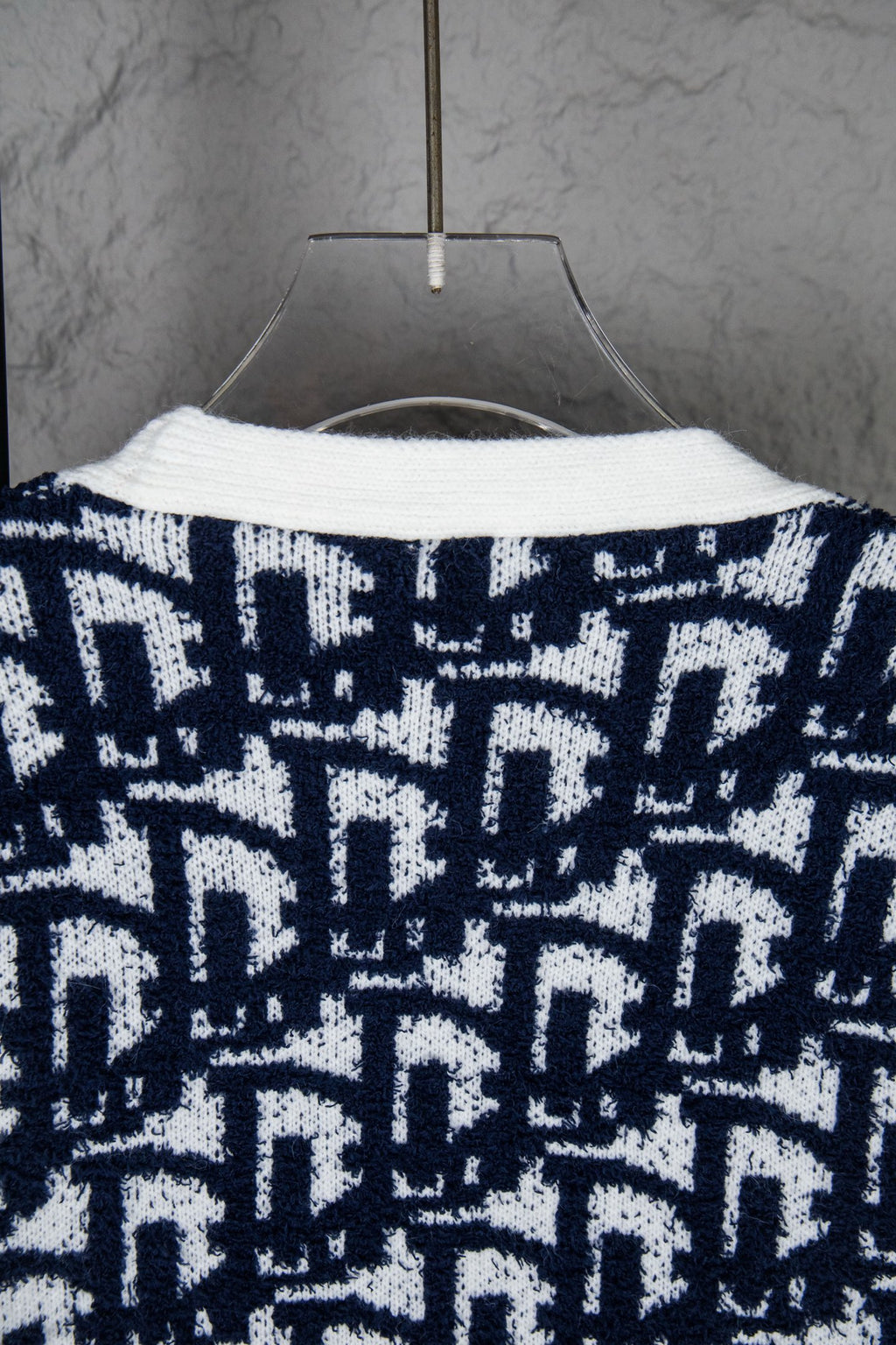 Knit cardigan back with navy-and-white geometric pattern and curved neckline