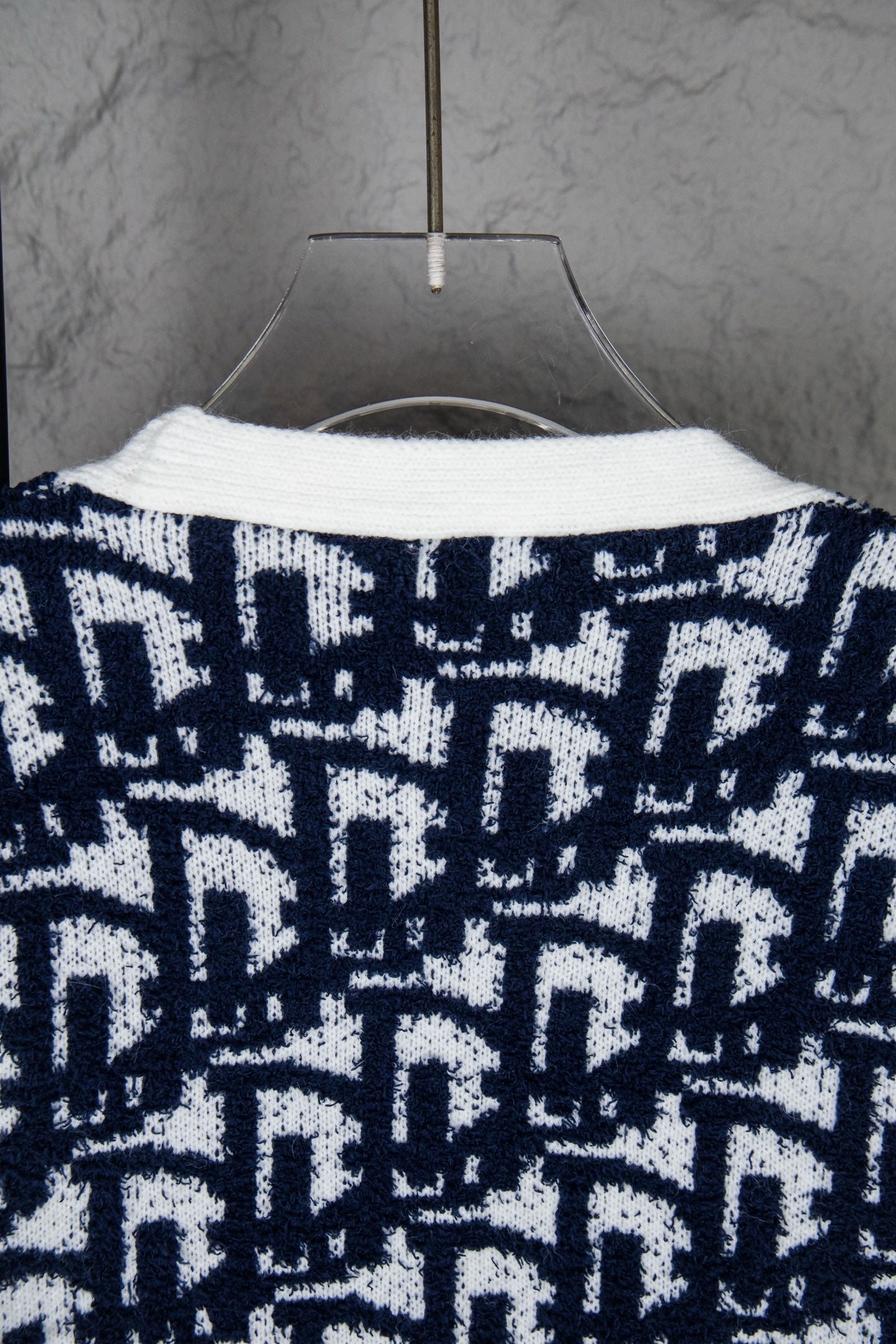 Knit cardigan back with navy-and-white geometric pattern and curved neckline