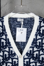 Knit cardigan neckline with white trim and Dior label tag
