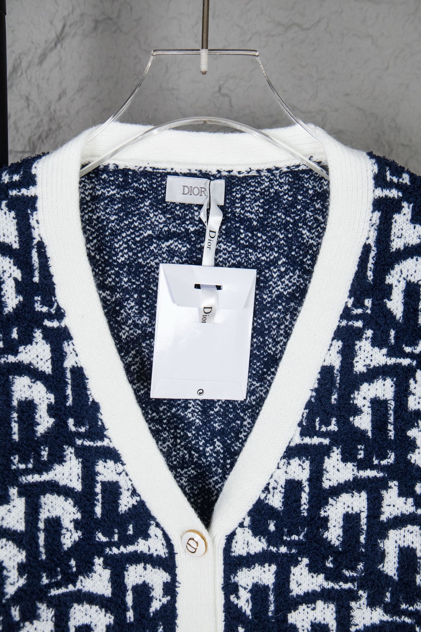 Knit cardigan neckline with white trim and Dior label tag