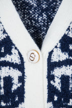 Knit cardigan button with gold D emblem on white trim
