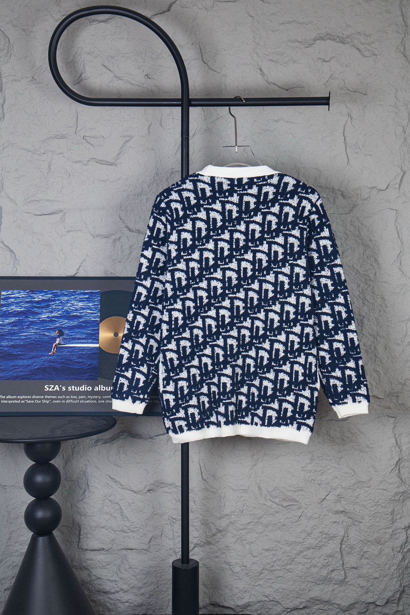 Long-sleeve knit cardigan with navy-and-white geometric pattern, ribbed cuffs