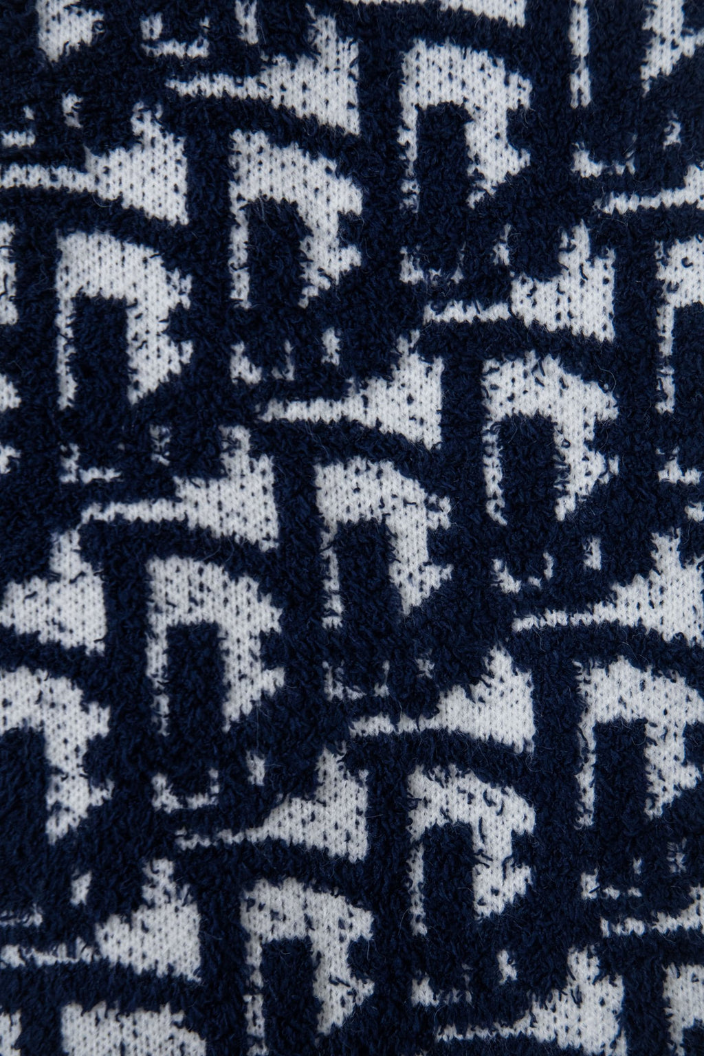 Navy-and-white knit fabric with allover geometric pattern texture