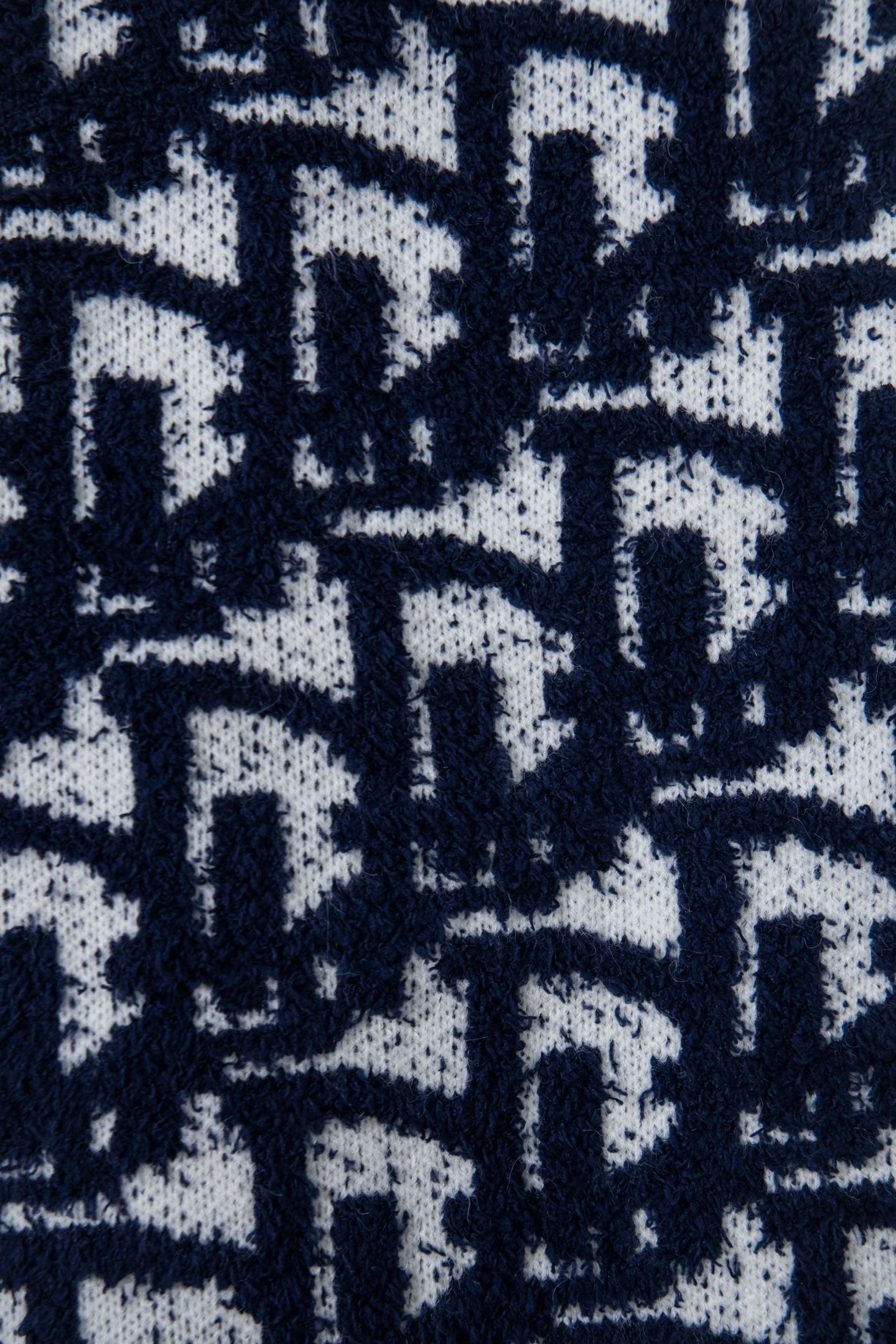 Navy-and-white knit fabric with allover geometric pattern texture