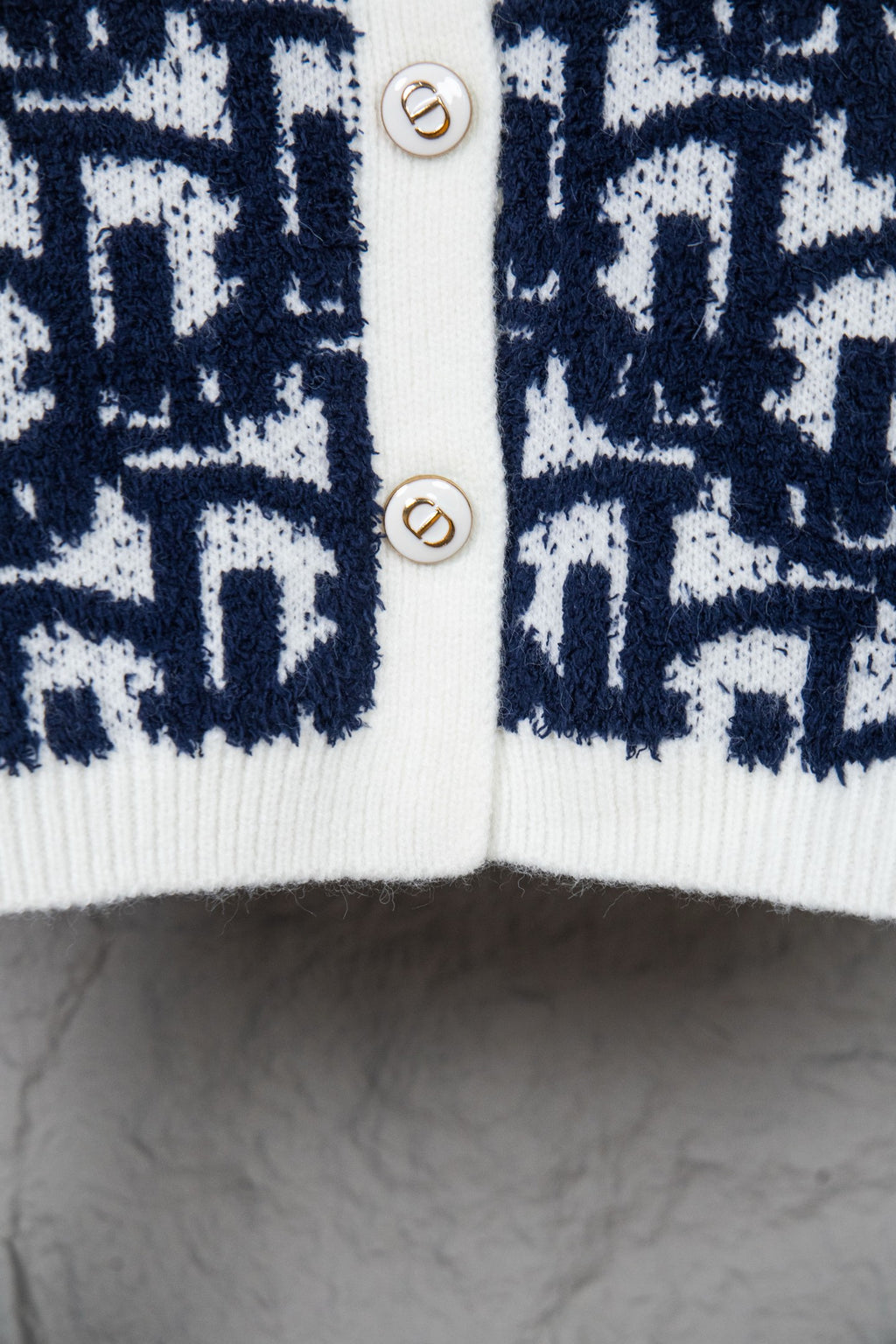 Dior long knit cardigan with navy patterned front and white button placket
