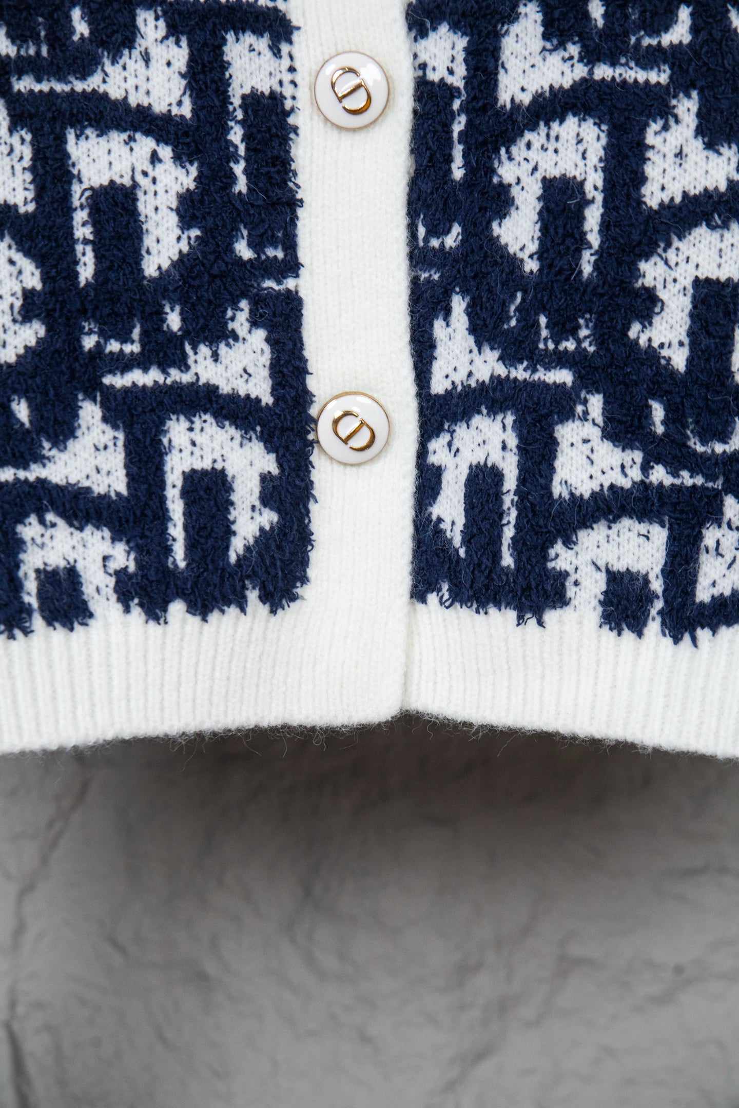 Dior long knit cardigan with navy patterned front and white button placket