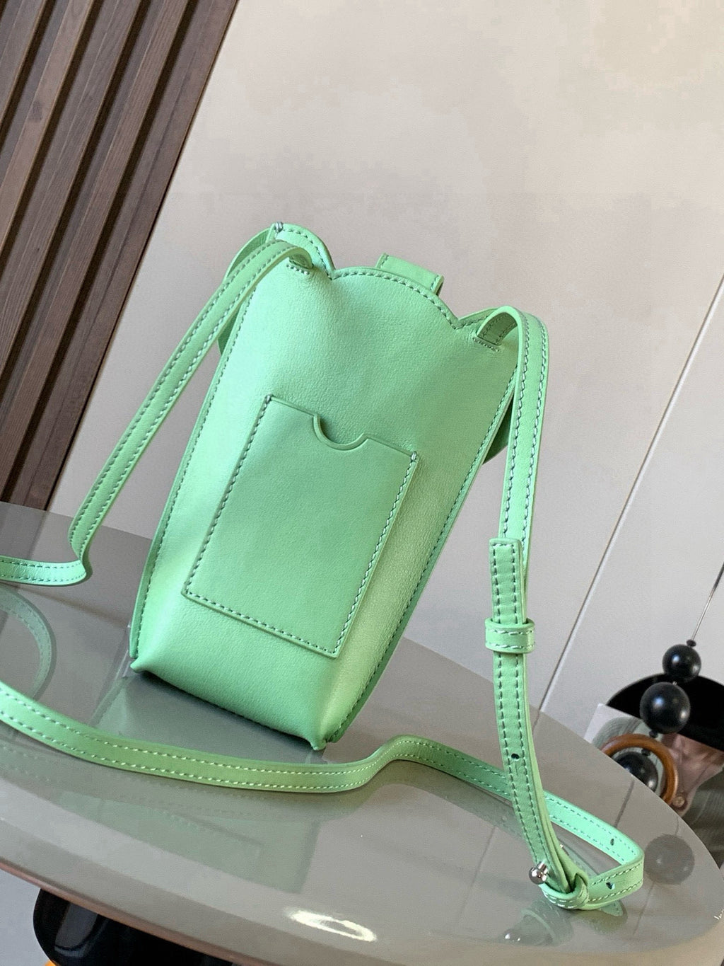 Loewe mint green leather small bucket bag with flap, pocket front, and long strap