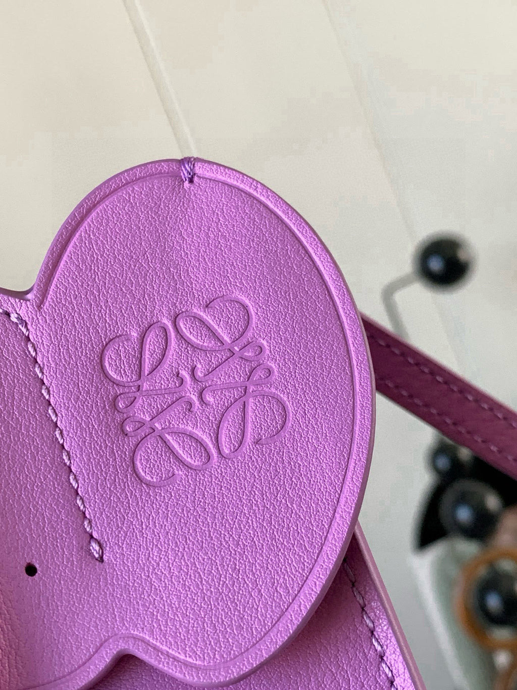 Loewe bag lilac leather base detail with embossed logo medallion