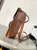 Loewe small leather crossbody bag, tan-brown, with logo patch and carry strap