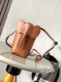 Loewe small leather crossbody bag with top handle and sculpted flap, tan-brown