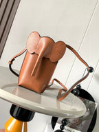 Loewe small leather crossbody bag with top handle and sculpted flap, tan-brown