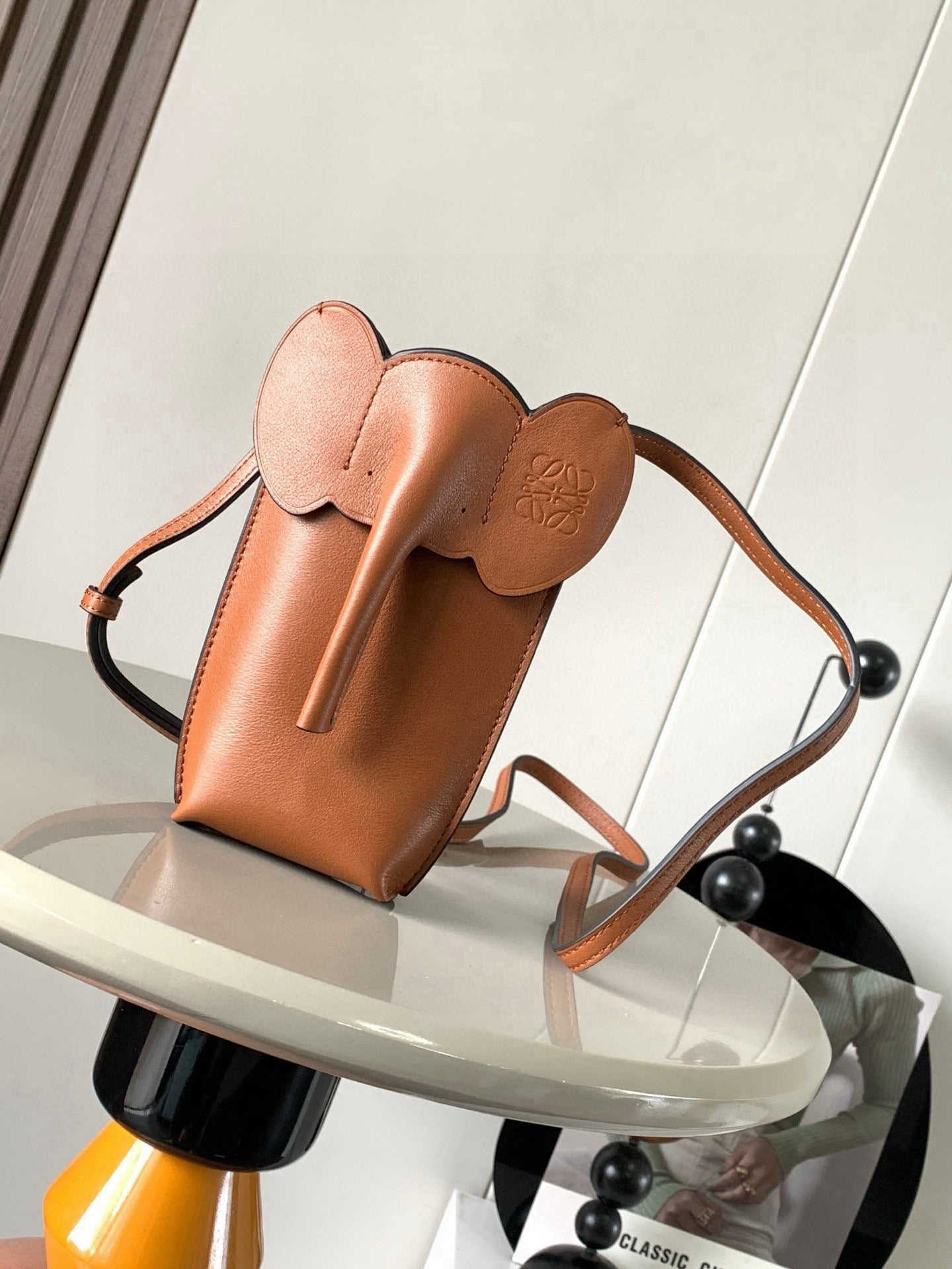 Loewe small leather crossbody bag with top handle and sculpted flap, tan-brown