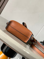 Loewe small leather crossbody bag, tan-brown, with side seam and strap hardware