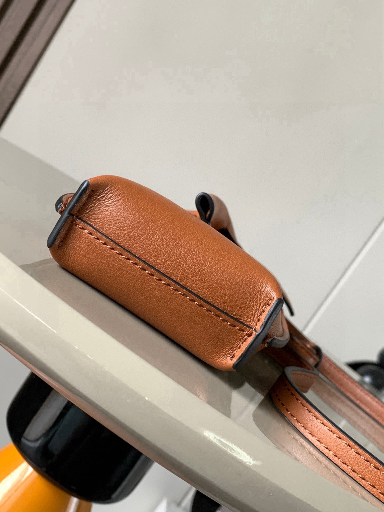 Loewe small leather crossbody bag, tan-brown, with side seam and strap hardware