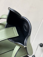 Mint green and dark interior mini bag with rounded opening and stitched edge detailing