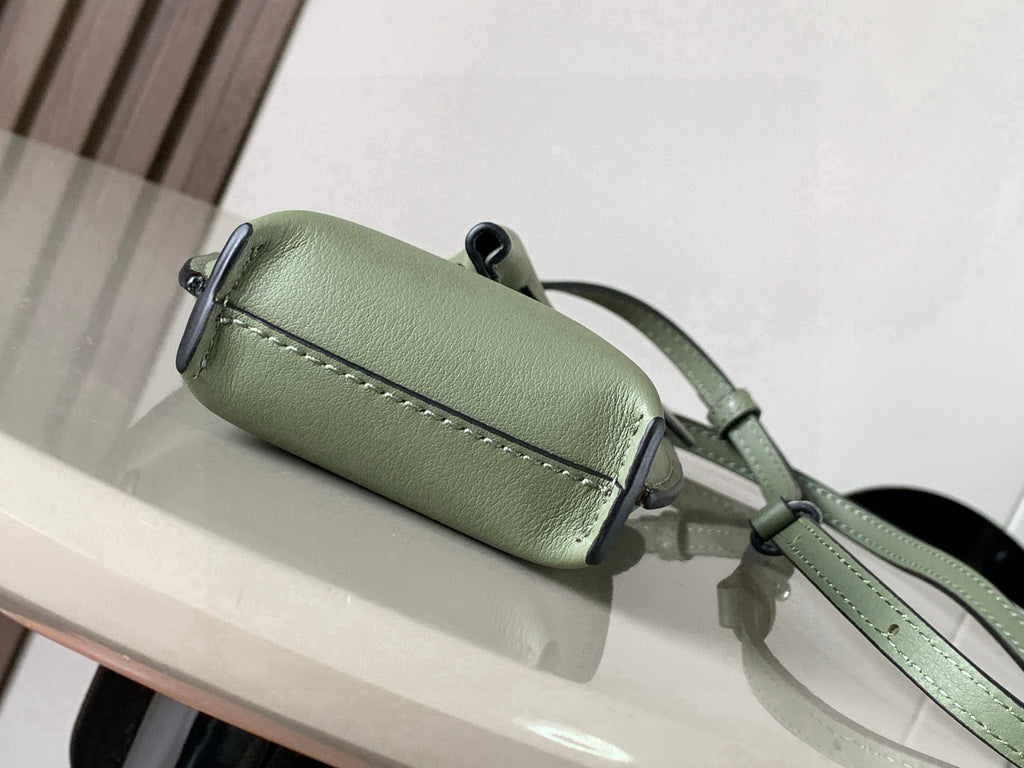 Mint green leather mini bag with top flap and magnetic closure, front strap loop