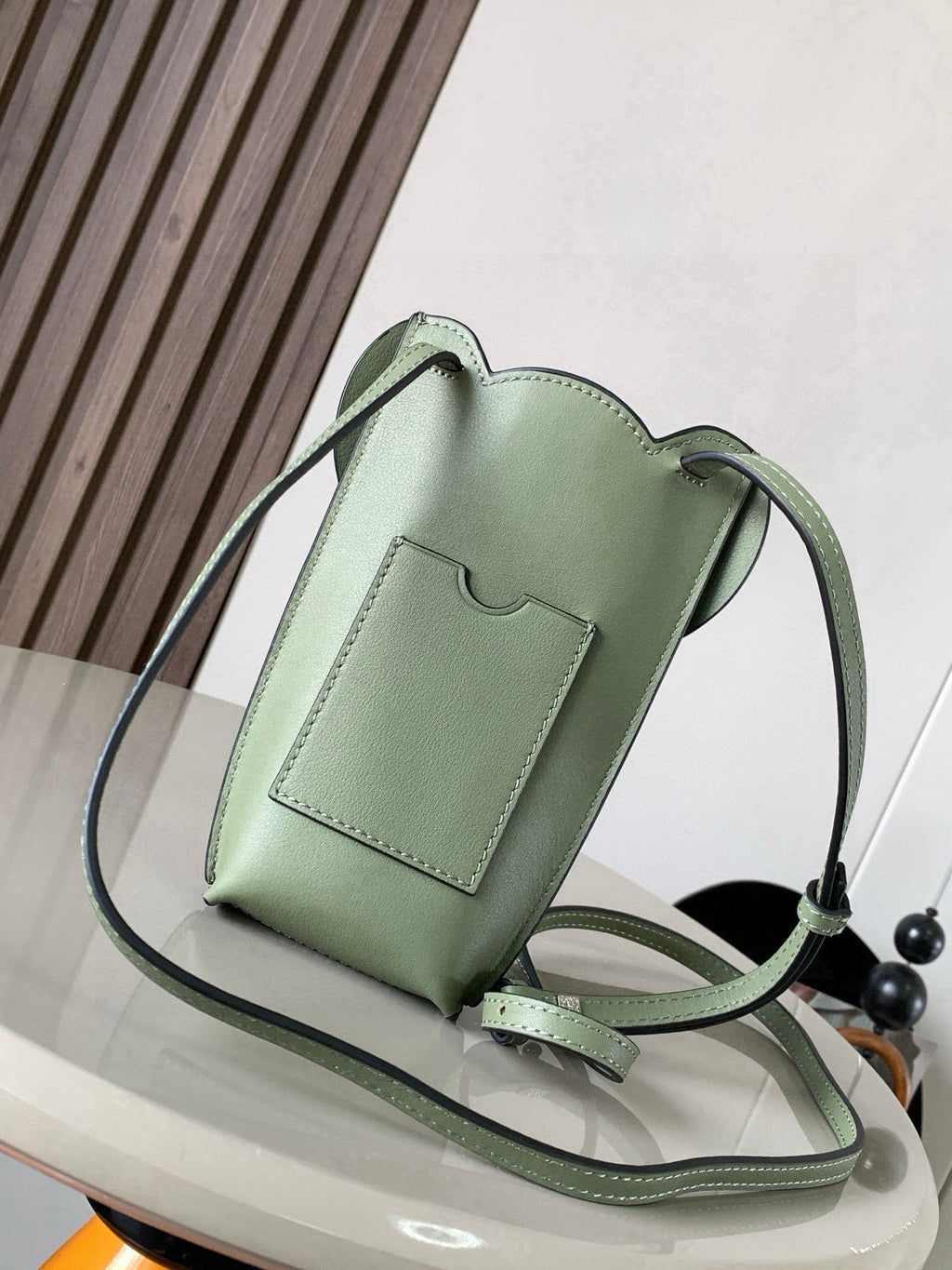 Mint green leather mini bag with crossbody strap and front pocket panel detail