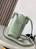 Mint green leather mini bag with crossbody strap and front pocket panel detail