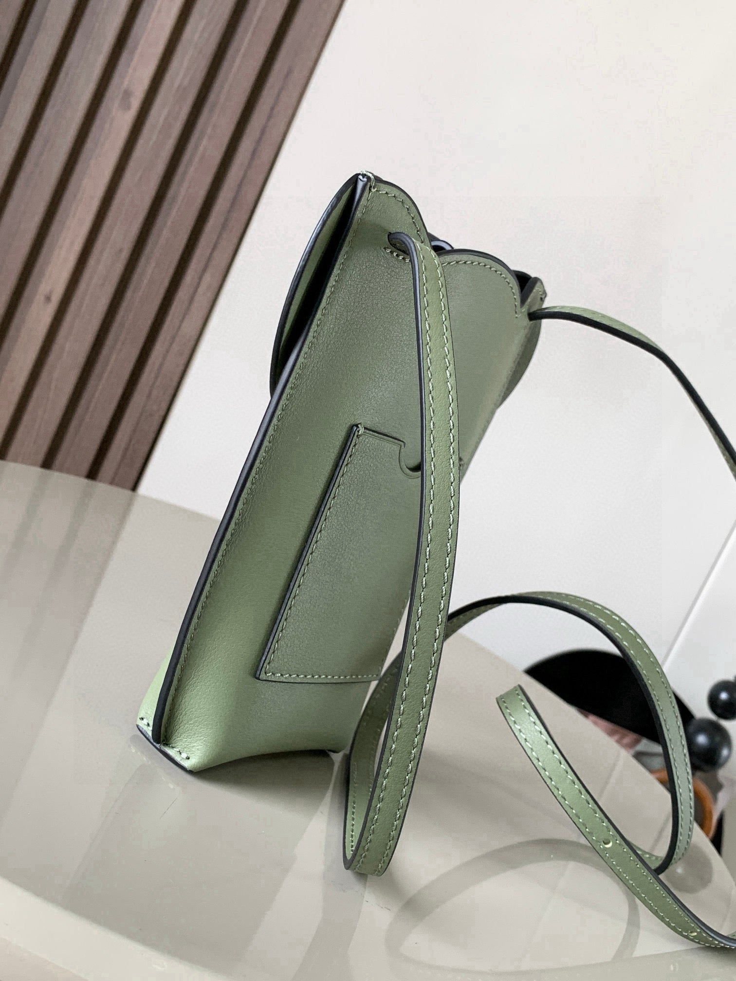 Mint green leather mini crossbody bag with structured sides and adjustable shoulder strap
