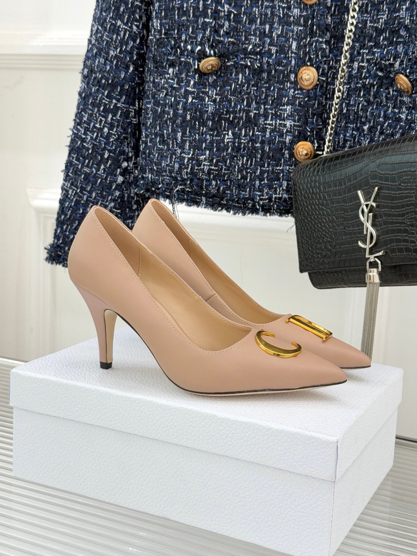 Beige Dior pointed-toe stiletto pumps with gold logo detail on the vamp