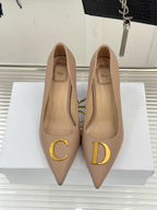 Beige Dior pointed-toe stiletto pumps front view with gold C and D logo