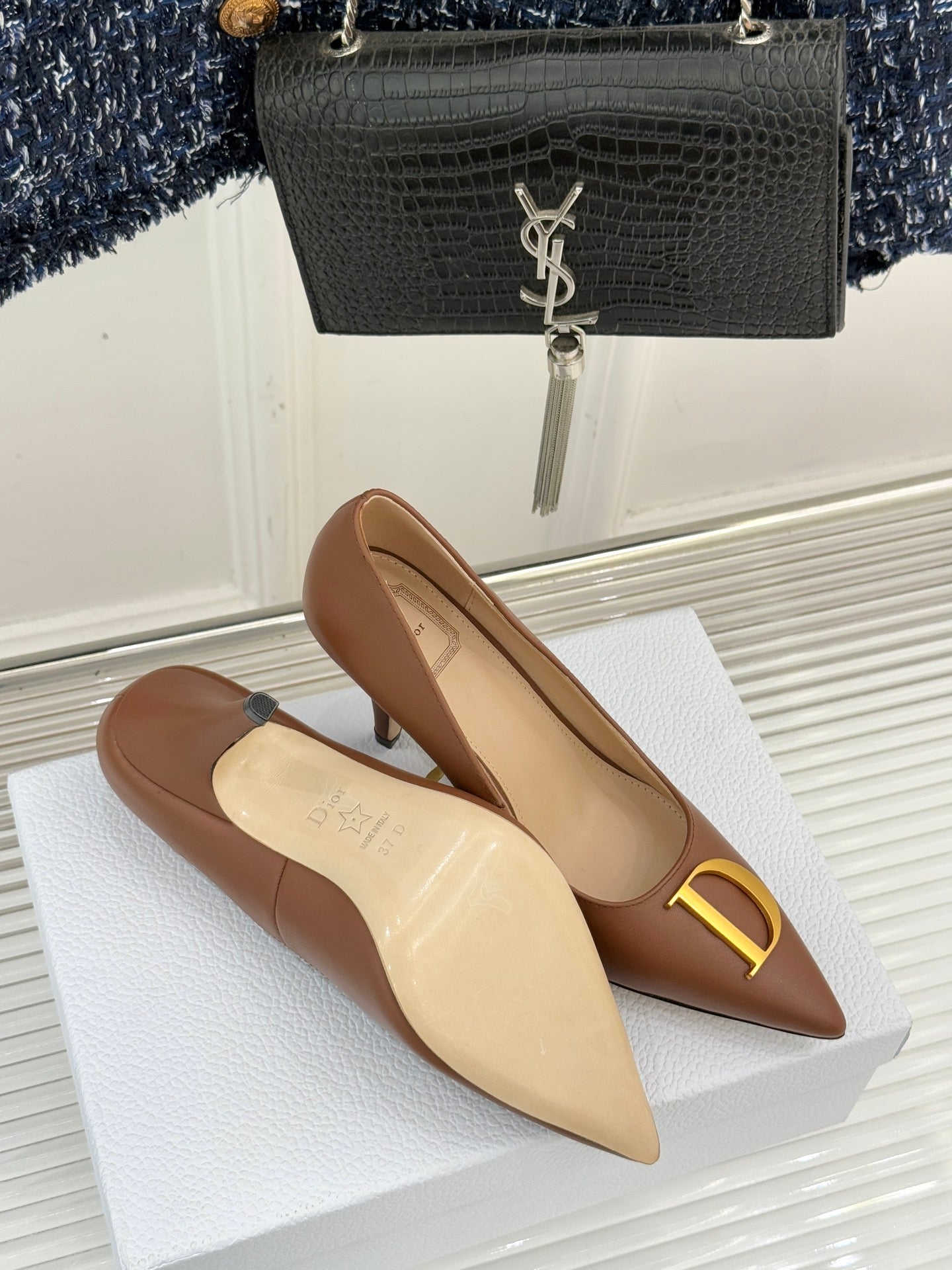 Dior ladies' tan pointed-toe pumps with slim heel and gold D emblem on vamp
