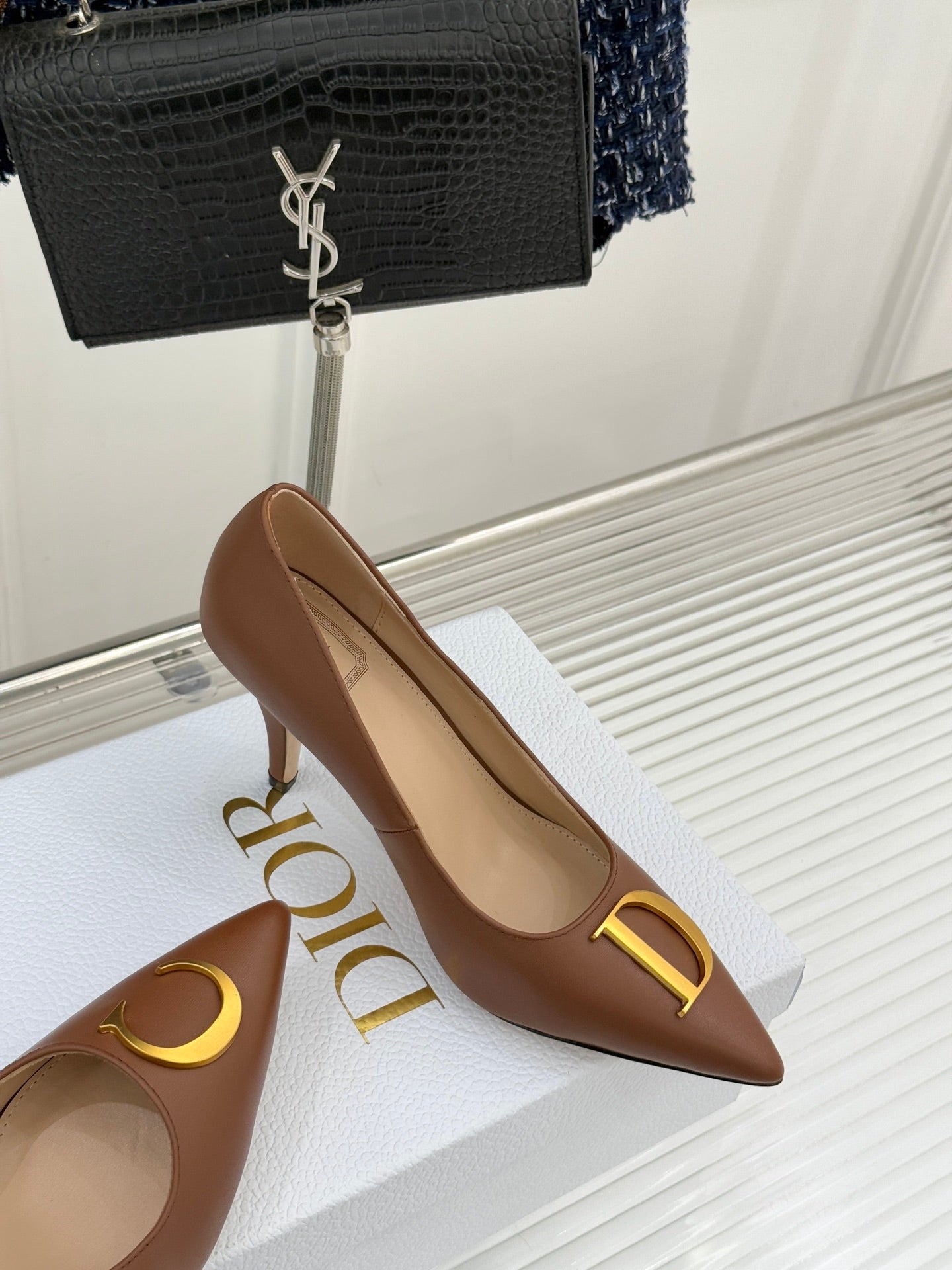 Dior ladies' tan pointed-toe pumps with slim heel and gold D emblem on vamp