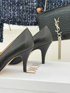 Black mid-height stiletto pumps with curved toe and visible heel