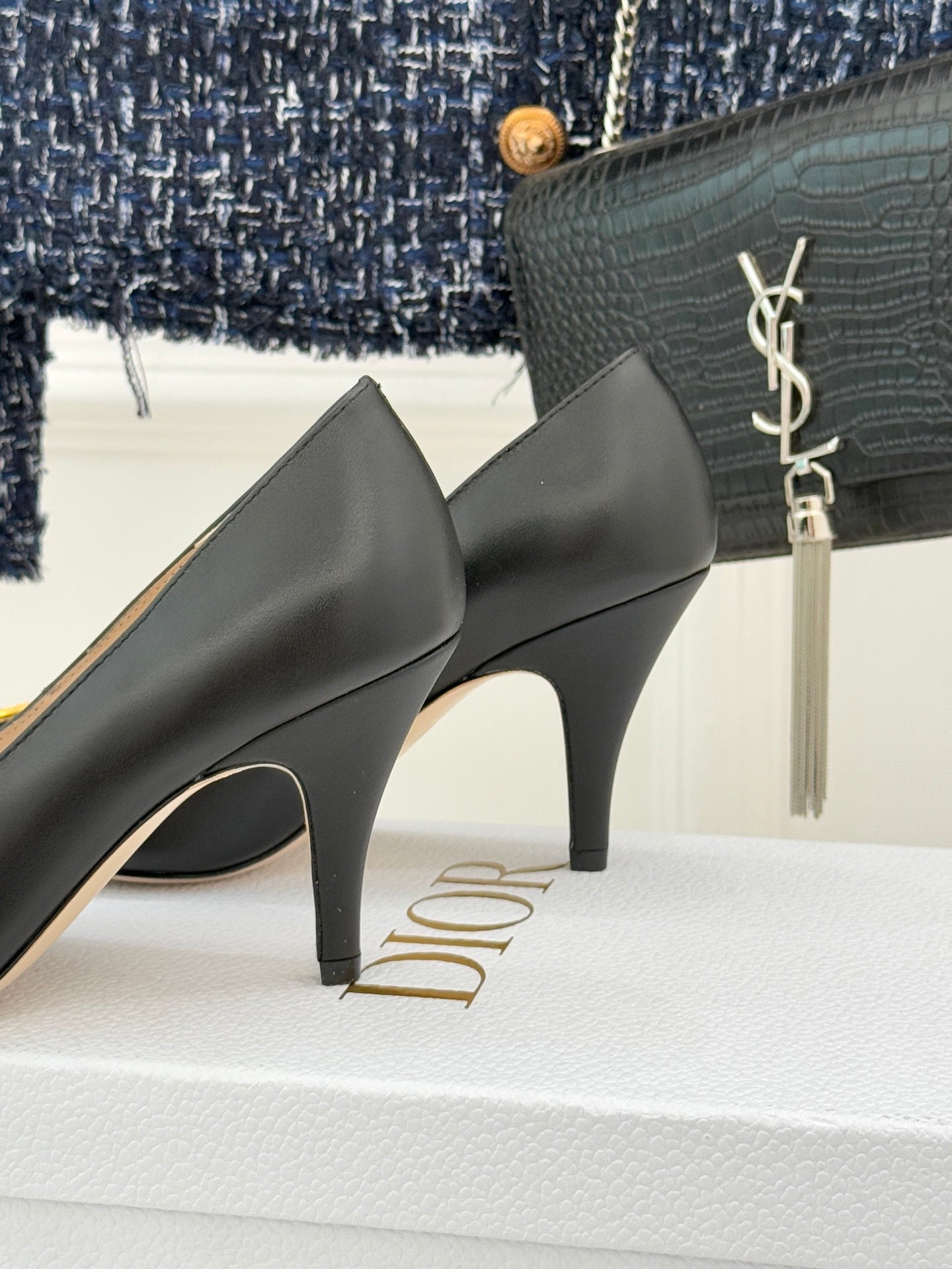 Black mid-height stiletto pumps with curved toe and visible heel