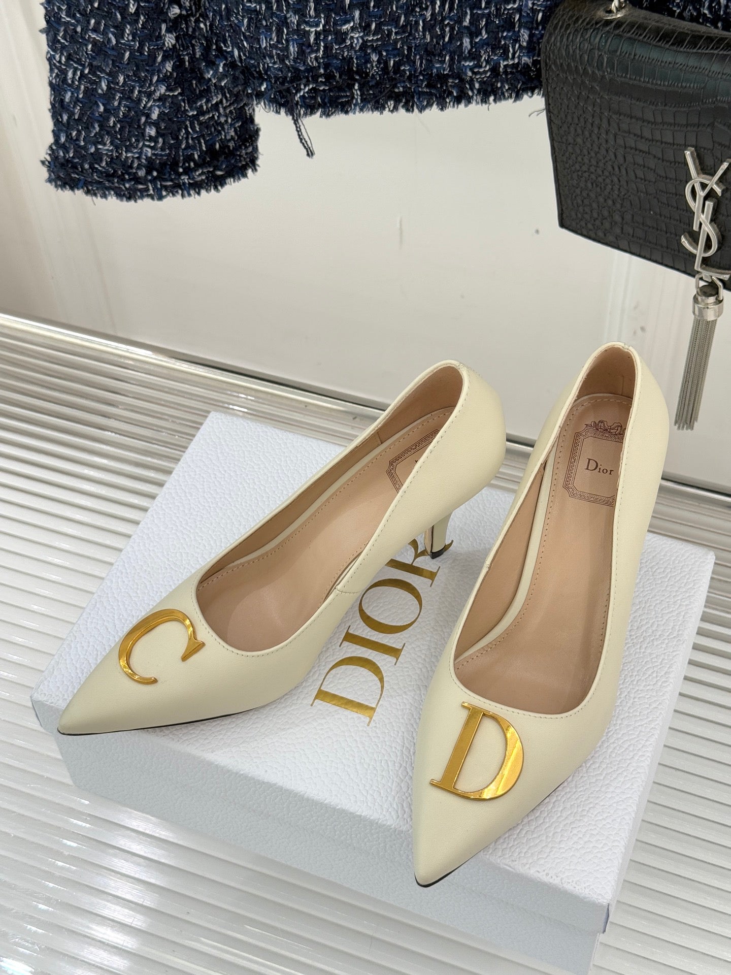 Cream pointed-toe high-heel pumps with gold C and D accents