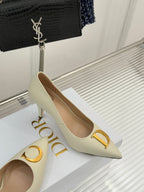 Cream pointed-toe high-heel pumps with gold D ornament