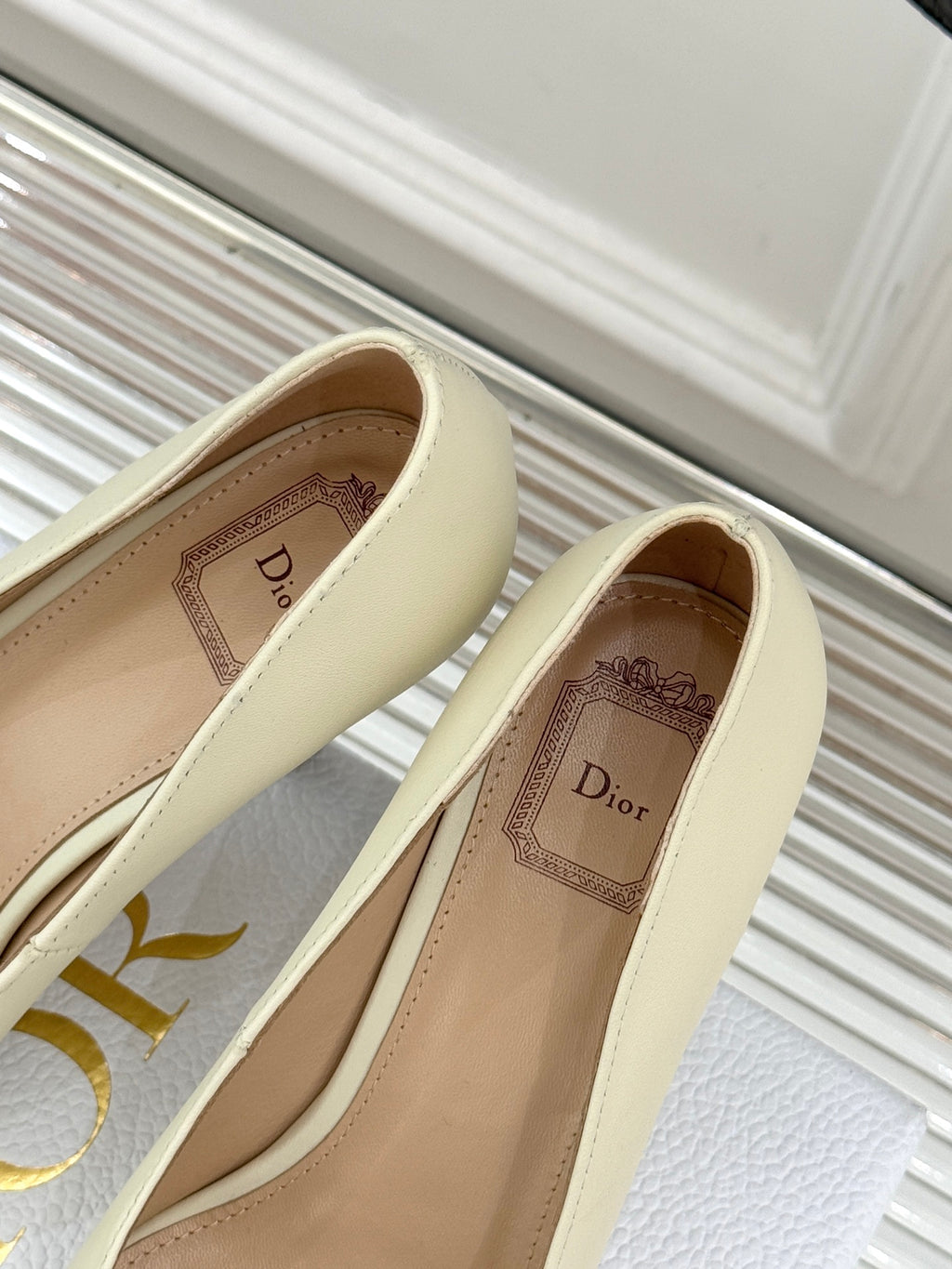 Cream pointed-toe high-heel pumps showing Dior logo on the insole